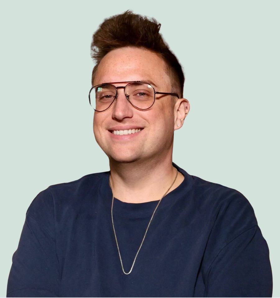 Clay Klaus-Wade, smiling, in glasses and a navy T-shirt
